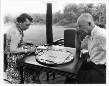 Dwight Eisenhower and Mamie Eisenhower playing scrabble. Black and white.