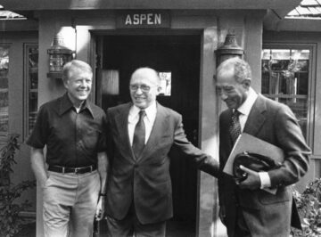 Black and white photo of Carter, Begin and Sadat in front of a lodge called Aspen